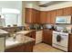 Kitchen with wood cabinets, granite counters, and white appliances at 4727 Wild Draw Dr, North Las Vegas, NV 89031