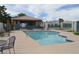 Community pool and spa with seating and a clubhouse at 4727 Wild Draw Dr, North Las Vegas, NV 89031