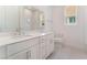 Bright bathroom with dual sinks, white cabinets, modern fixtures, and decorative tile flooring at 7132 Silver Palace St, Las Vegas, NV 89131