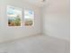 Bedroom featuring neutral carpet with two windows and neighborhood views at 7132 Silver Palace St, Las Vegas, NV 89131