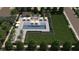 Aerial view of the community pool with lounge chairs, umbrellas, a covered area, and manicured landscaping at 7132 Silver Palace St, Las Vegas, NV 89131