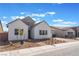 Charming home showcases a brick driveway, three gables, and a two-car garage, all under a partly cloudy sky at 7132 Silver Palace St, Las Vegas, NV 89131