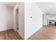 Hallway with wood floors leads to a bathroom and kitchen with white cabinets at 7132 Silver Palace St, Las Vegas, NV 89131