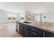 Kitchen island with granite countertop and stainless steel dishwasher overlooking a living area at 7132 Silver Palace St, Las Vegas, NV 89131