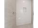 New shower with mosaic tile and a built-in shelf at 7132 Silver Palace St, Las Vegas, NV 89131