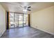 Spacious living room with wood-look flooring and sliding glass doors leading to balcony at 725 N Royal Crest Cir # 214, Las Vegas, NV 89169