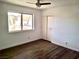 This bedroom features wood floors, neutral walls, and a window with a view of the outdoors at 611 E Fairway Rd, Henderson, NV 89015