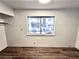 The bedroom showcases wood floors, neutral walls, and a window for a bright and airy feel at 611 E Fairway Rd, Henderson, NV 89015