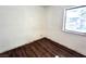 This bedroom has wood floors, white walls and a window for natural light and ventilation at 611 E Fairway Rd, Henderson, NV 89015