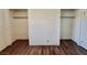 Bedroom with light-colored walls and wood floors, featuring built-in closets at 611 E Fairway Rd, Henderson, NV 89015