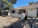 Charming single-story home featuring a xeriscaped yard, covered entrance, and a pink front door at 611 E Fairway Rd, Henderson, NV 89015