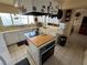 This kitchen features an island cooktop, white cabinets, and modern appliances at 611 E Fairway Rd, Henderson, NV 89015