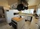 This kitchen features an island cooktop, white cabinets, and modern appliances at 611 E Fairway Rd, Henderson, NV 89015