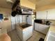 This kitchen features an island cooktop, white cabinets, and modern appliances at 611 E Fairway Rd, Henderson, NV 89015