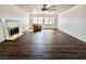 Spacious living room featuring dark hardwood flooring, a fireplace, and large windows at 611 E Fairway Rd, Henderson, NV 89015