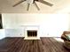 Bright living room showcasing a fireplace with white mantel and modern, dark hardwood floors at 611 E Fairway Rd, Henderson, NV 89015