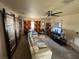Relaxing living room with barn-door design, carpet flooring, and entertainment center at 611 E Fairway Rd, Henderson, NV 89015