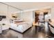 Modern studio bedroom with dark wood floors and white finishes, including a mirrored headboard wall at 4381 W Flamingo Rd # 1905, Las Vegas, NV 89103