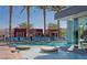 Resort-style pool area with sun loungers and tropical landscaping, offering a relaxing outdoor experience at 4381 W Flamingo Rd # 1905, Las Vegas, NV 89103