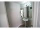 Powder room with pedestal sink, mirrored wall, and gray walls at 5713 Heineken Dr, North Las Vegas, NV 89031