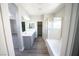 Bright bathroom featuring double sinks, separate shower and soaking tub, and wood-look flooring at 5713 Heineken Dr, North Las Vegas, NV 89031