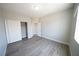 Neutral bedroom with wood-look floors, closet, and door leading to hallway at 5713 Heineken Dr, North Las Vegas, NV 89031