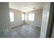 This bedroom features wood-look flooring and natural light from the large windows at 5713 Heineken Dr, North Las Vegas, NV 89031