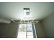 Modern chandelier hanging in a room with large glass sliding doors at 5713 Heineken Dr, North Las Vegas, NV 89031