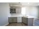 Kitchen area showcasing gray cabinets, white countertops, stainless sink, and built-in wine rack at 5713 Heineken Dr, North Las Vegas, NV 89031