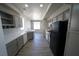 Bright kitchen features gray cabinets, white countertops, stainless sink, and wood-look flooring at 5713 Heineken Dr, North Las Vegas, NV 89031