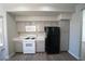 Kitchen featuring gray cabinets, white countertops, a microwave, gas range, and black refrigerator at 5713 Heineken Dr, North Las Vegas, NV 89031