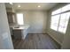 Cozy kitchenette with stainless steel sink, ample natural light, and gray cabinets at 5713 Heineken Dr, North Las Vegas, NV 89031
