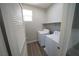 Bright laundry room with wood-look flooring, washer, and dryer ready for immediate use at 5713 Heineken Dr, North Las Vegas, NV 89031