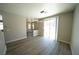 Bright living room with wood floors, modern light fixture and sliding glass doors to backyard at 5713 Heineken Dr, North Las Vegas, NV 89031