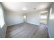 Spacious main bedroom with wood-look floors, attached bathroom, and natural light at 5713 Heineken Dr, North Las Vegas, NV 89031