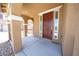 Covered front porch featuring decorative columns and a stylish, solid front door at 5713 Heineken Dr, North Las Vegas, NV 89031