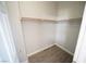 Spacious walk-in closet with wood rod shelving and modern flooring at 5713 Heineken Dr, North Las Vegas, NV 89031