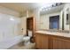 Clean bathroom with a tub, shower, and wood vanity at 10001 Peace Way # 2324, Las Vegas, NV 89147