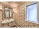 Elegant bathroom with patterned wallpaper and a pedestal sink at 1420 S 8Th St, Las Vegas, NV 89104