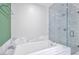 Modern bathroom featuring a soaking tub with marble surround and a glass-enclosed shower with tiled walls at 4471 Dean Martin Dr # 2205, Las Vegas, NV 89103