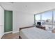 Bright bedroom featuring a large window with city views, and hardwood floors at 4471 Dean Martin Dr # 2205, Las Vegas, NV 89103