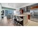 Modern kitchen featuring granite countertops, stainless steel appliances, and a view of the living area with city skyline at 4471 Dean Martin Dr # 2205, Las Vegas, NV 89103