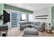 Bright and airy living area featuring a comfortable sectional, minimalist decor, and expansive windows showcasing city views at 4471 Dean Martin Dr # 2205, Las Vegas, NV 89103