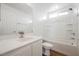 A bathroom with a single sink vanity, a shower-tub combination, and a window for natural light at 1161 Gecko Rd, Henderson, NV 89002