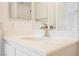 Bathroom vanity with single sink, modern faucet, and a mirror at 1161 Gecko Rd, Henderson, NV 89002