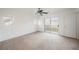 Spacious bedroom with a ceiling fan and sliding glass doors leading to a balcony at 1161 Gecko Rd, Henderson, NV 89002