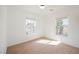 A bright bedroom with carpet floors and two windows at 1161 Gecko Rd, Henderson, NV 89002