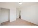 An empty bedroom featuring neutral carpet, a closet, and a door leading to another room at 1161 Gecko Rd, Henderson, NV 89002