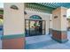 Building entrance featuring covered walkway with decorative pillars and a glass door at 1161 Gecko Rd, Henderson, NV 89002
