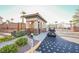 Community entrance gate with a security booth and palm tree accents at 1161 Gecko Rd, Henderson, NV 89002